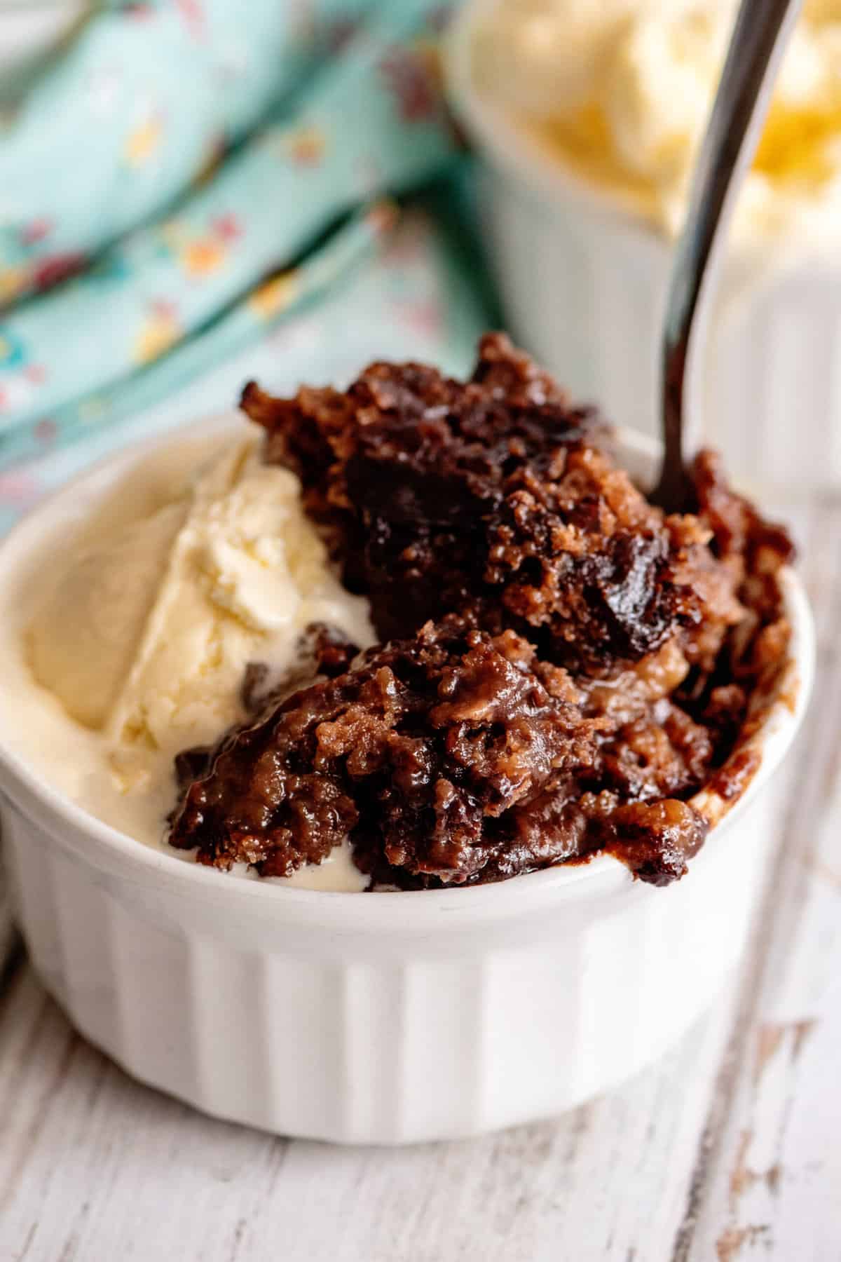 Bowl of chocolate cobbler with ice cream.
