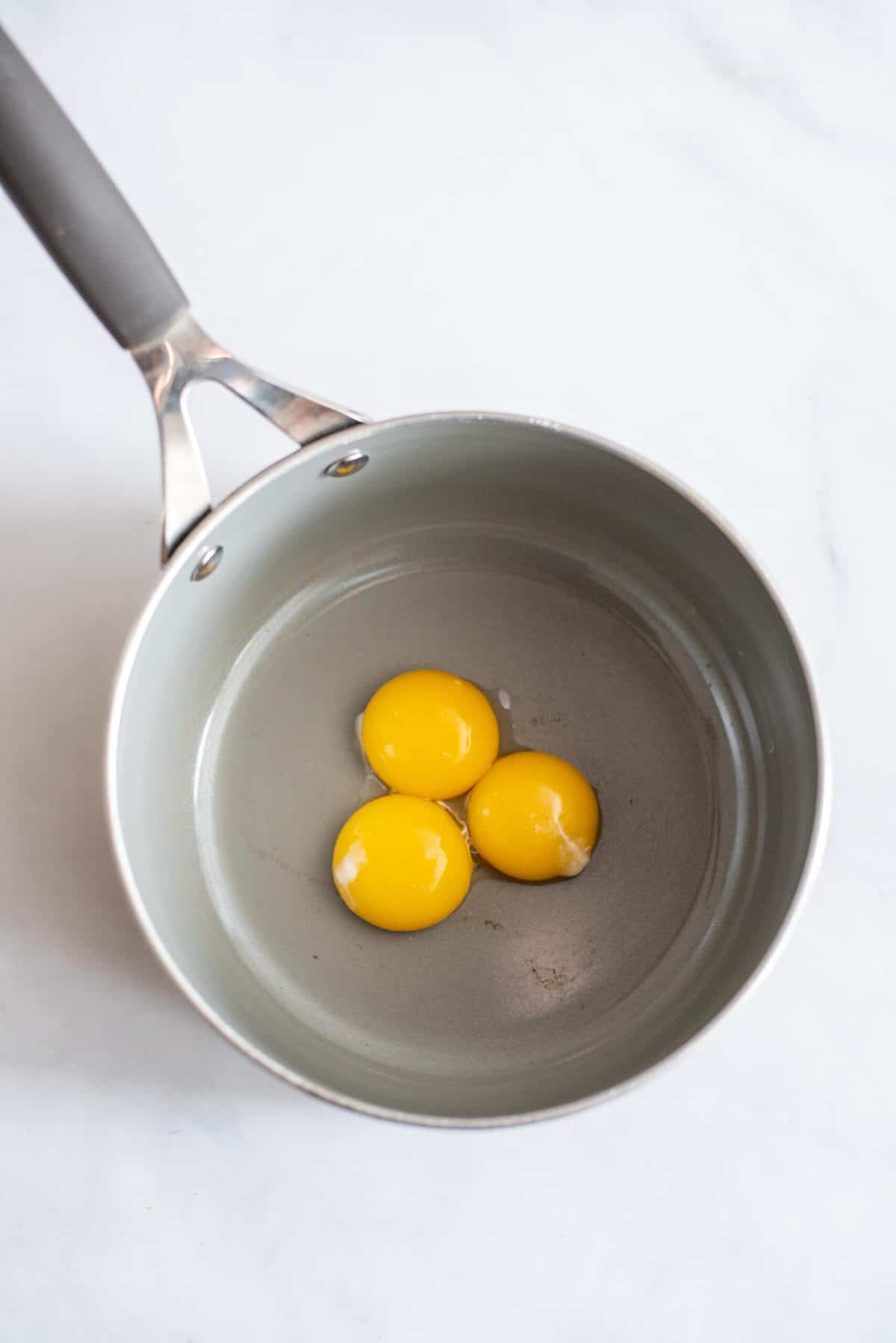 Egg yolks in saucepan.