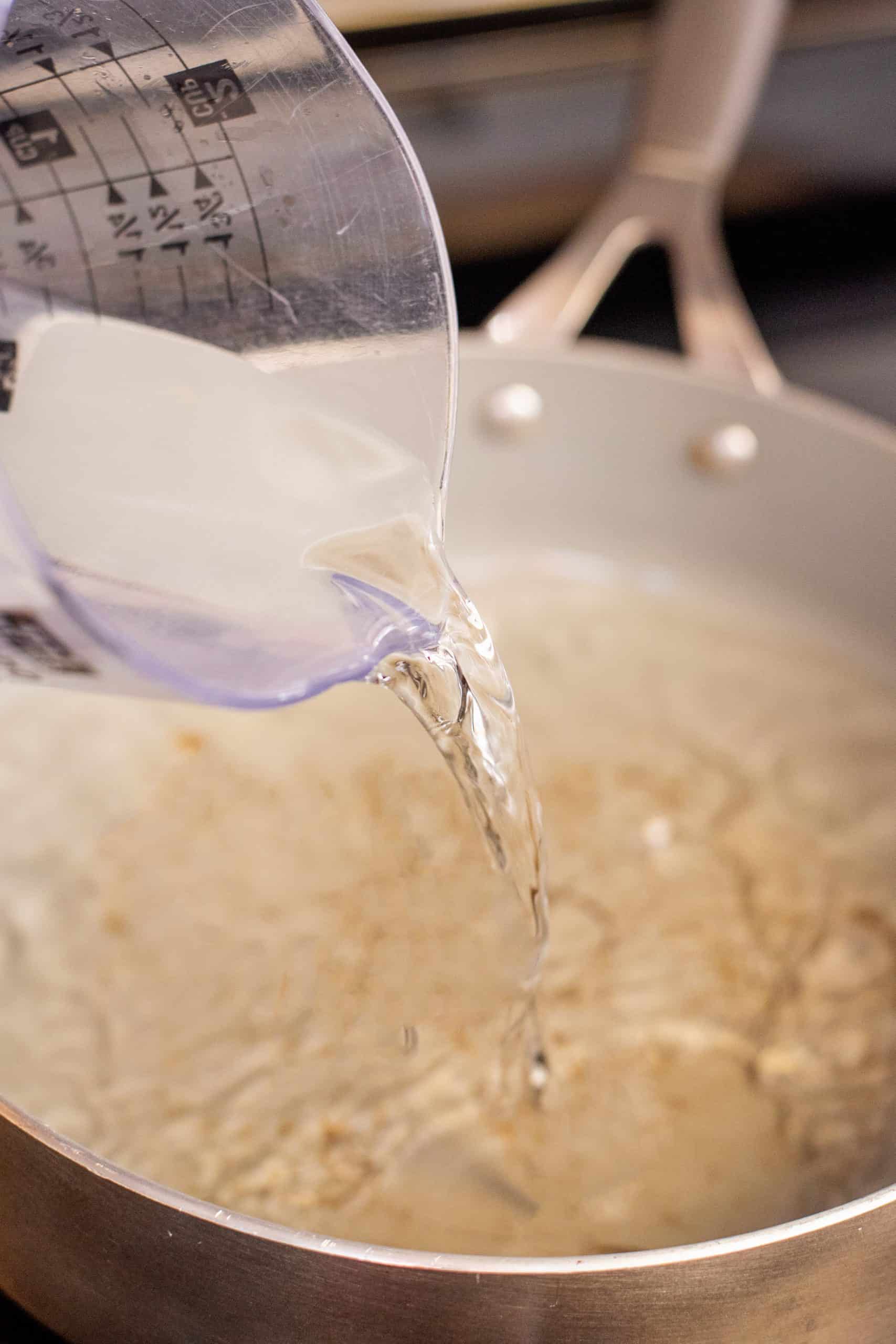 Pouring water into a skillet.