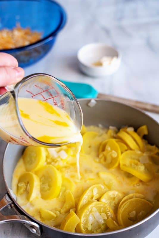 Add milk mixture to squash in the skillet.