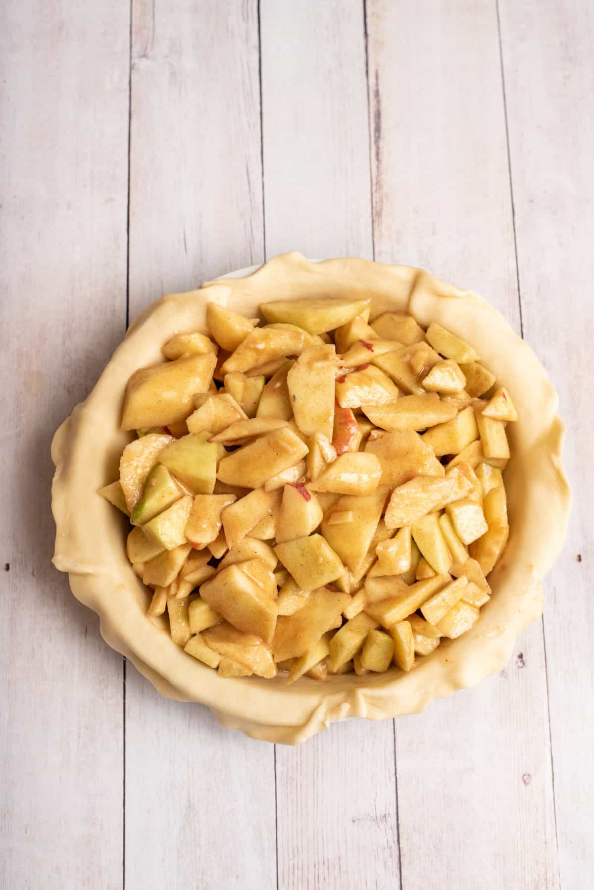 spoon apples into pie crust