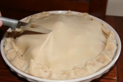 Poke knife holes in apple pie.