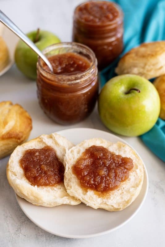 crock pot apple butter spread on a biscuit.