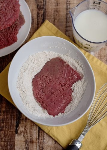 steak being coated in flour.