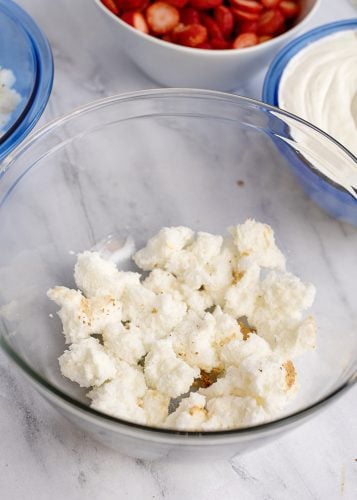 Assembling trifle - angel food cake pieces as bottom layer.