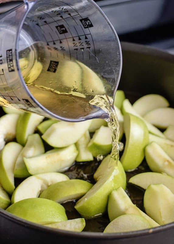 Add apple juice to slices in skillet.