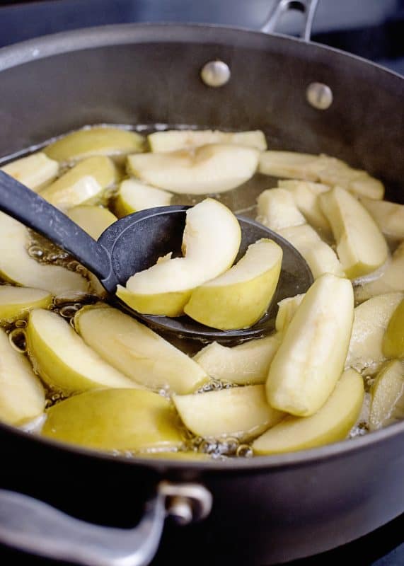 Remove apple slices from pan using a slotted spoon.