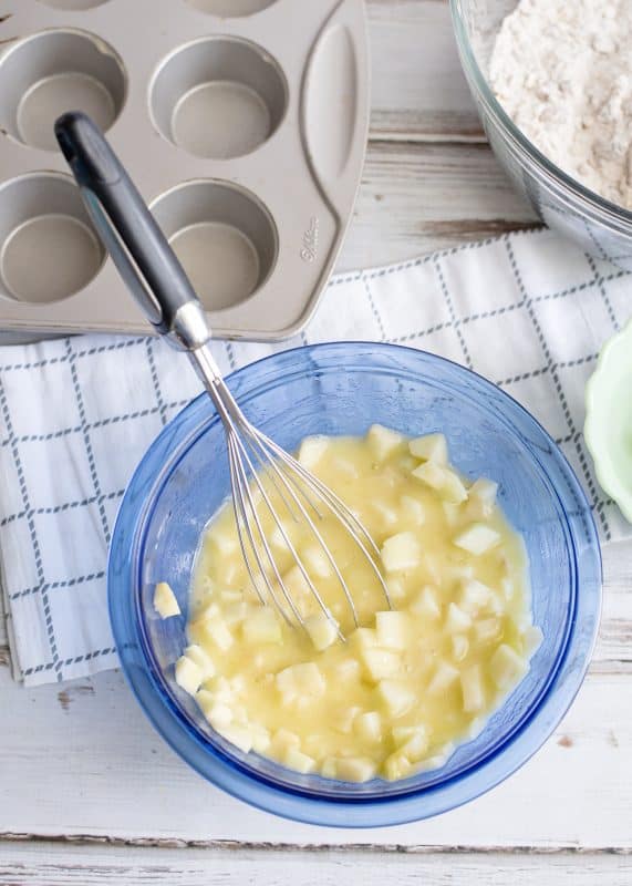 In a separate bowl, beat eggs then add oil, water, and apples.