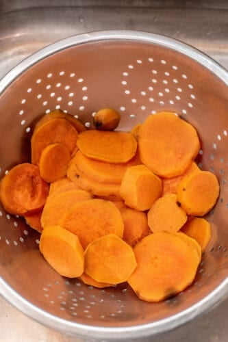 Draining sweet potato in colander.