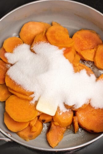 Add sugar to sweet potatoes in pot.