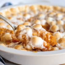 Spoonful of sweet potato casserole with marshmallows.
