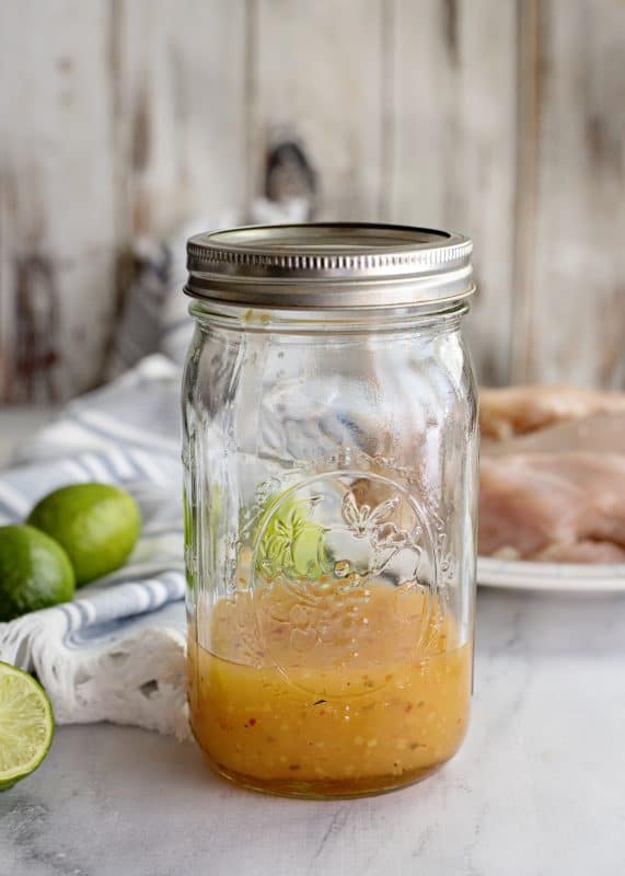 Marinade for grilled chicken tenders in jar.