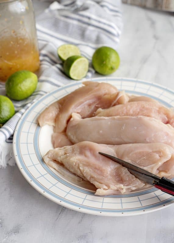 cutting chicken breasts into strips.