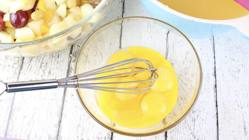 Beat egg yolks in bowl.