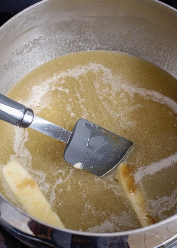 Caramel sauce boiling in saucepot.