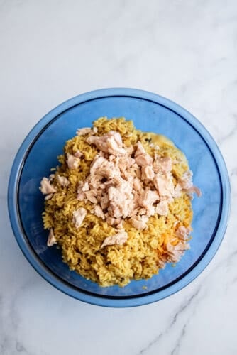 Added cooked rice and chicken to mixing bowl.