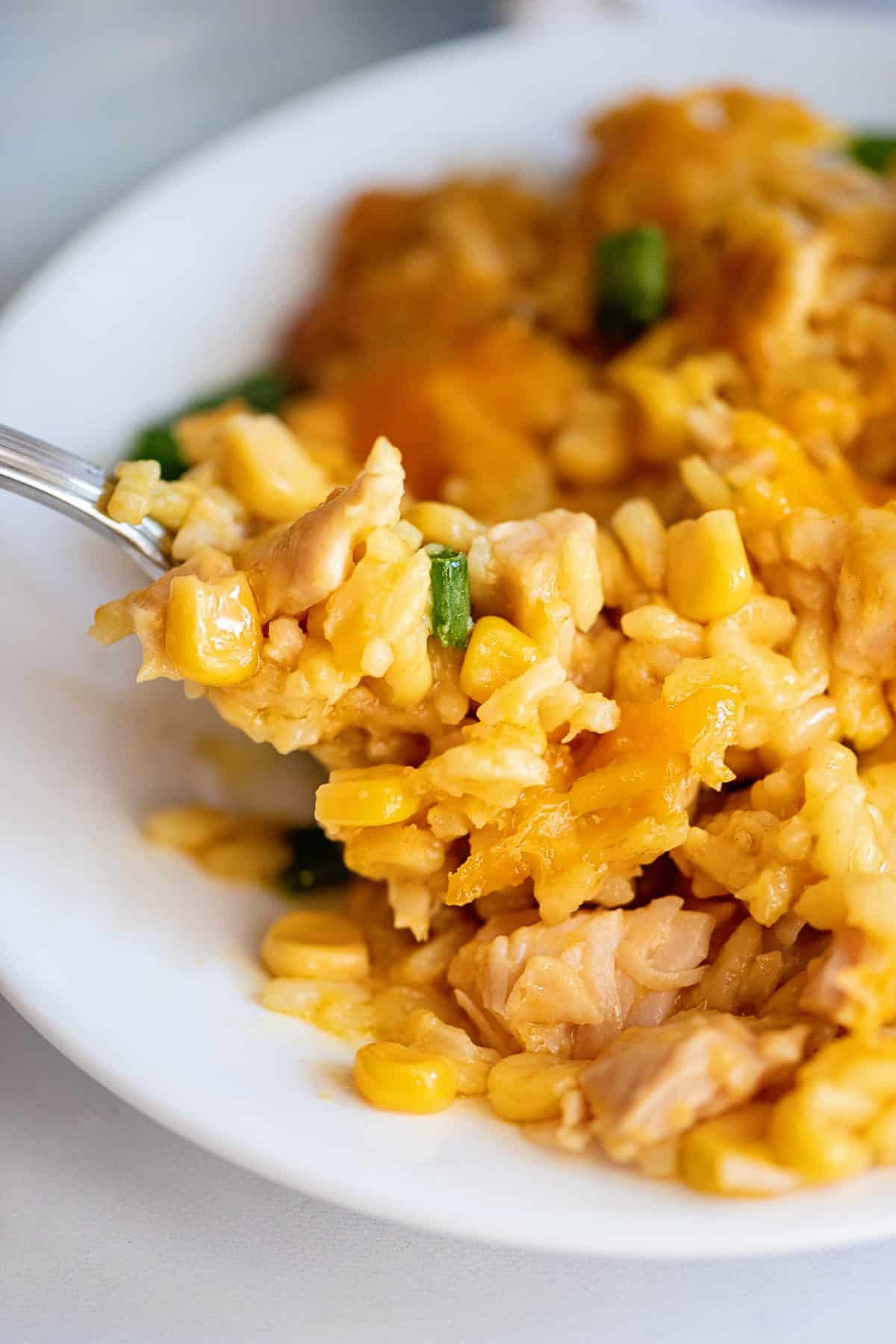 Forkful of cheesy chicken and corn casserole.