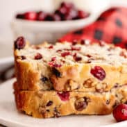 Two stacked slices of cranberry banana bread.