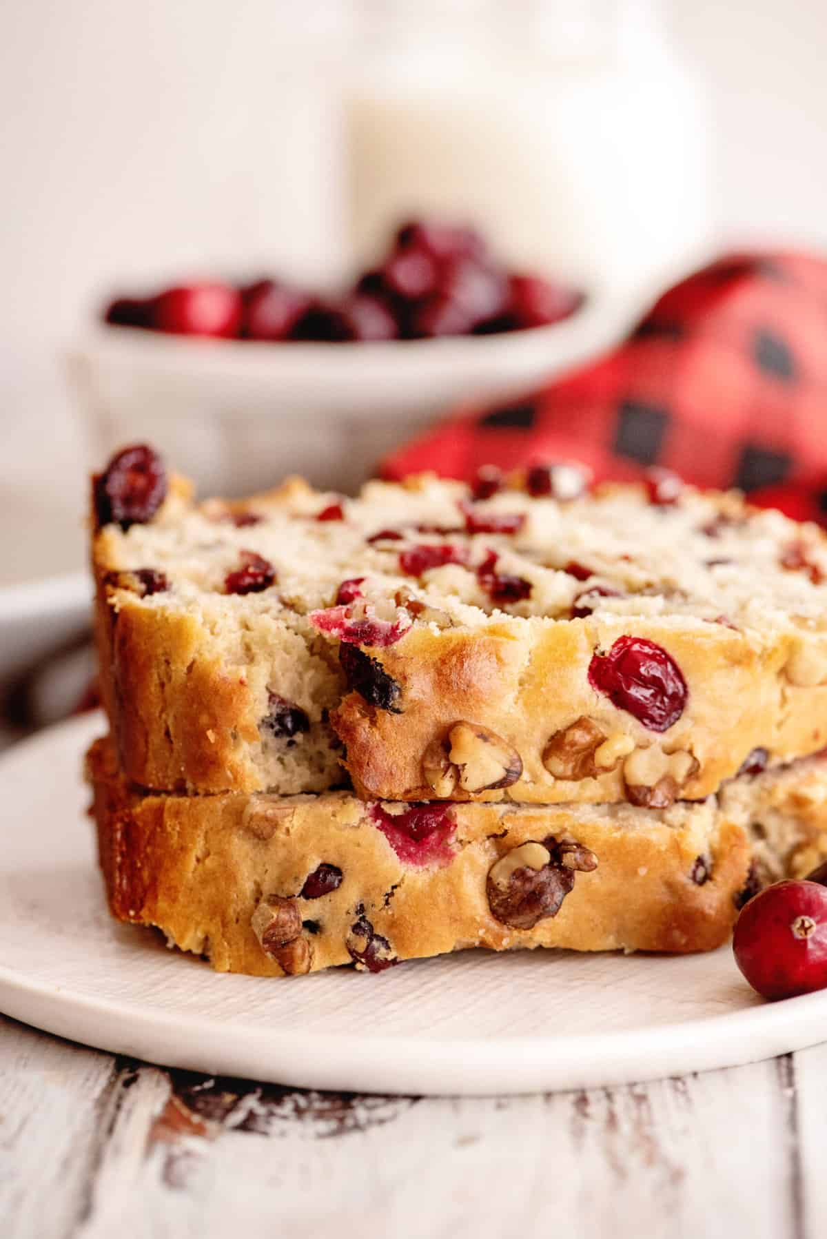 Two stacked slices of cranberry banana bread.