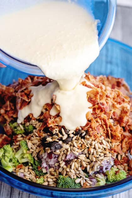 Pour dressing over salad in mixing bowl.