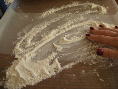 Place flour on surface lined with waxed paper.