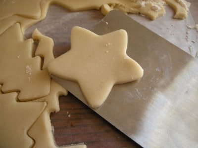 Carefully place Christmas cutout cookies on prepared baking sheet.