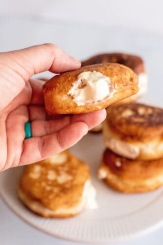 Hand showing filled mini Boston cream pie.