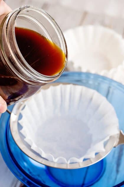 Place filter-lined strainer over large bowl and pour in half of the cold brew.