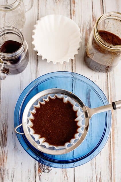 Pour coffee into strainer slowly.