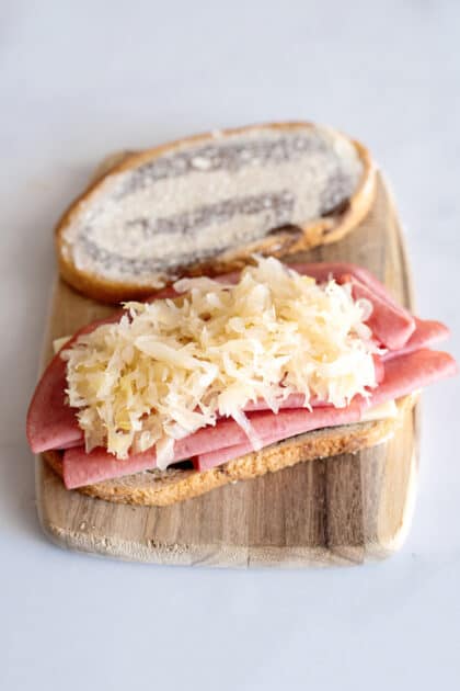 Add sauerkraut to sandwich.