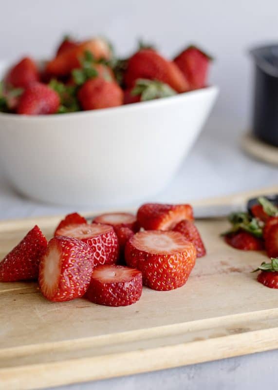 Slice strawberries in half.