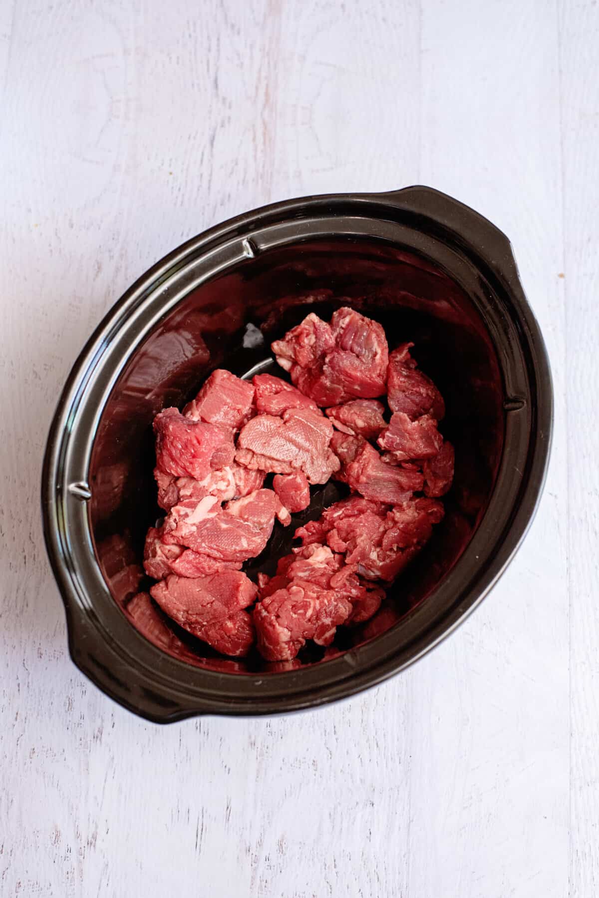 put meat in the slow cooker