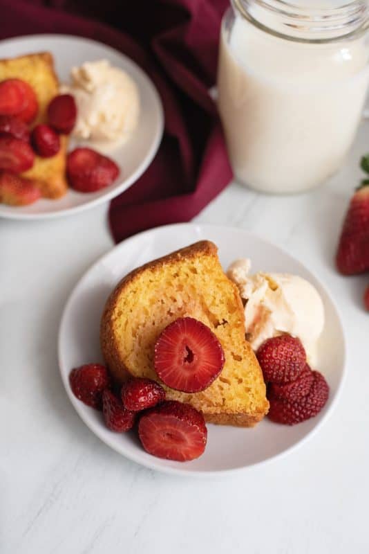 a simple cake slice with strawberries and whipped cream