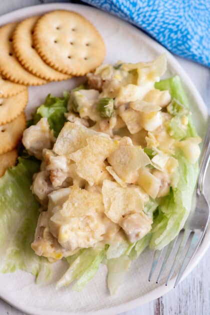 Hot chicken salad served on lettuce with Ritz crackers.