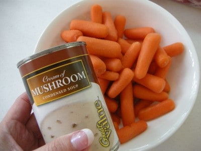 Can of mushroom soup with baby carrots (recipe ingredients).