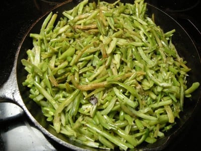 Stir green beans until tender.