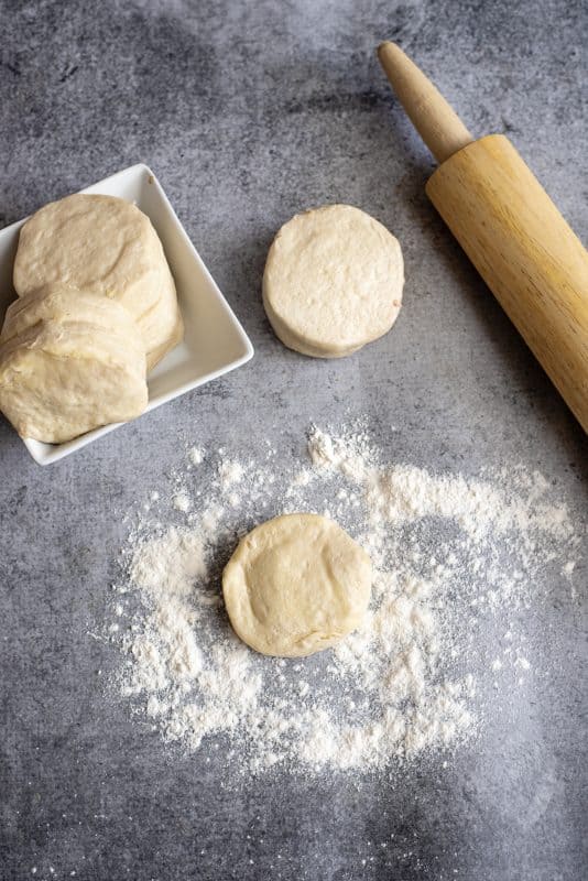 Place canned biscuits on a floured surface.