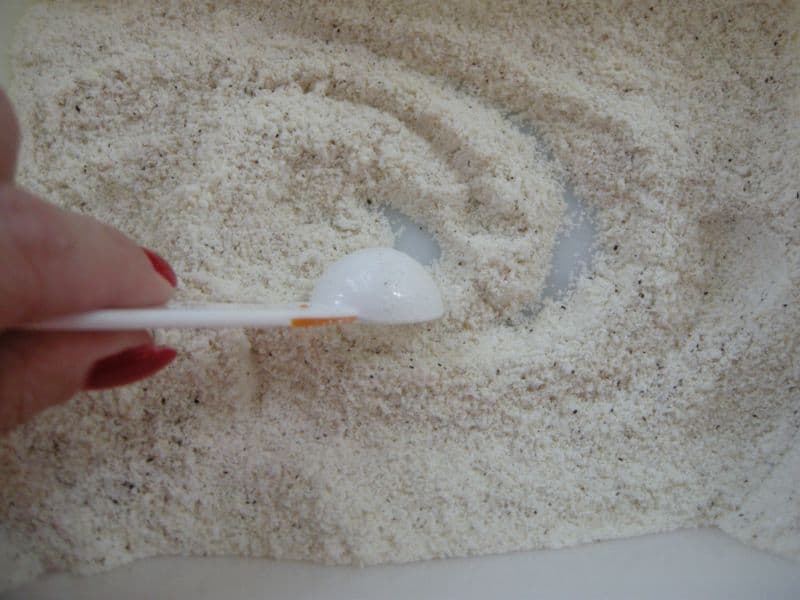 Stirring cornmeal, salt and pepper in bowl.