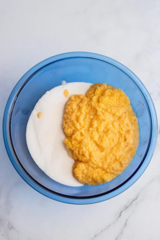 Mashed peaches and sugar in bowl.