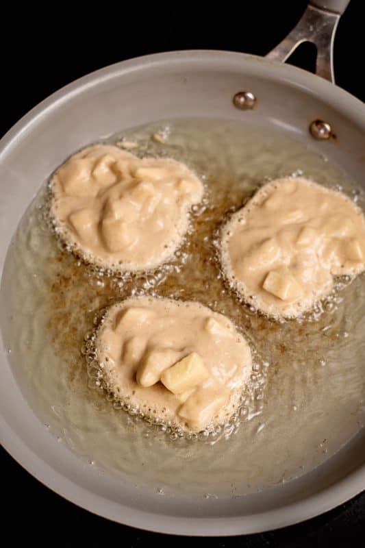 drop spoonfuls of the apple fritter batter into the pan of hot oil.