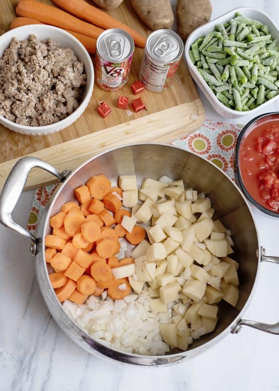 Dice carrots, potatoes, and onion and place in large pot.