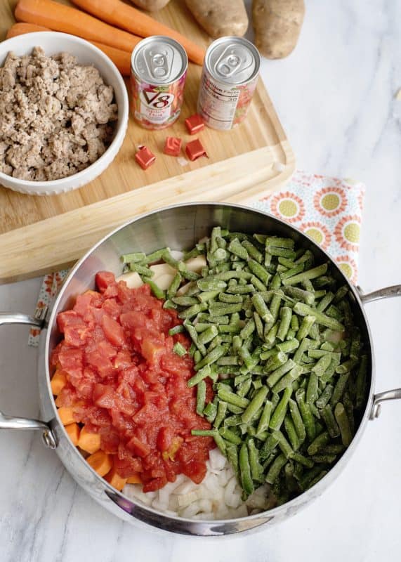 Add tomatoes and green beans to pot.