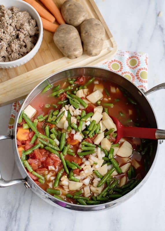 Bring your ground beef stew to a boil and then simmer until vegetables are tender.