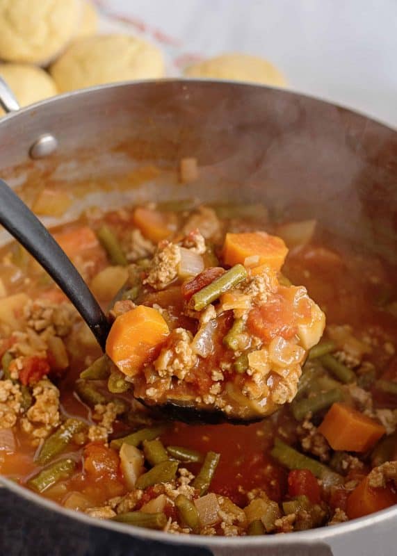 A large spoonful of ground beef stew.