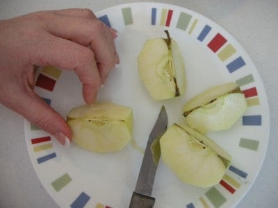 Cutting apples into sections.