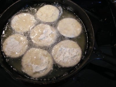 Place the coated eggplants in the hot oil.