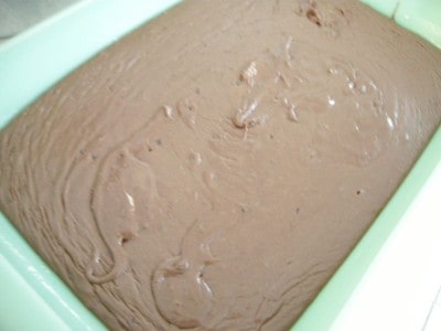 Pour the easy chocolate fudge into the greased pan and cool.