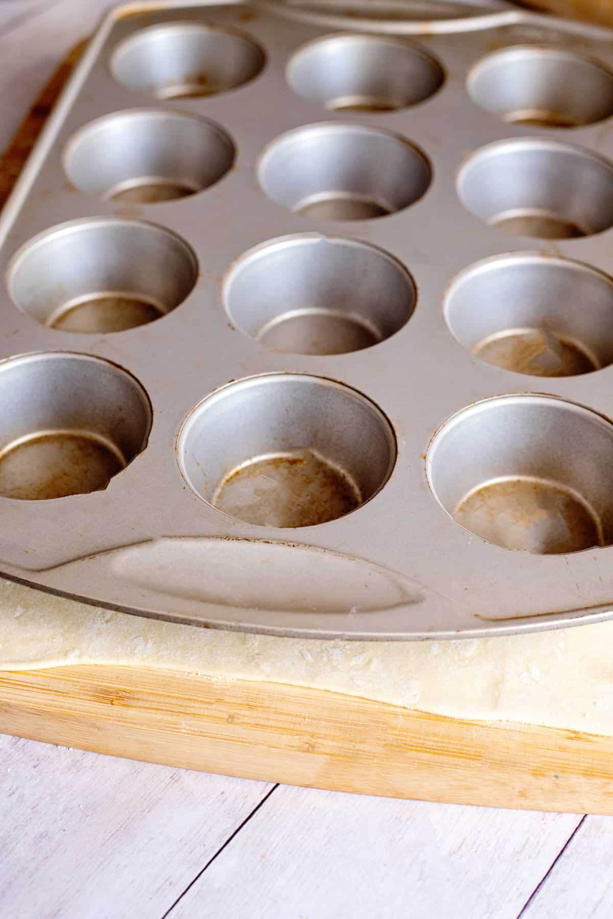 press muffin tin down on puff pastry