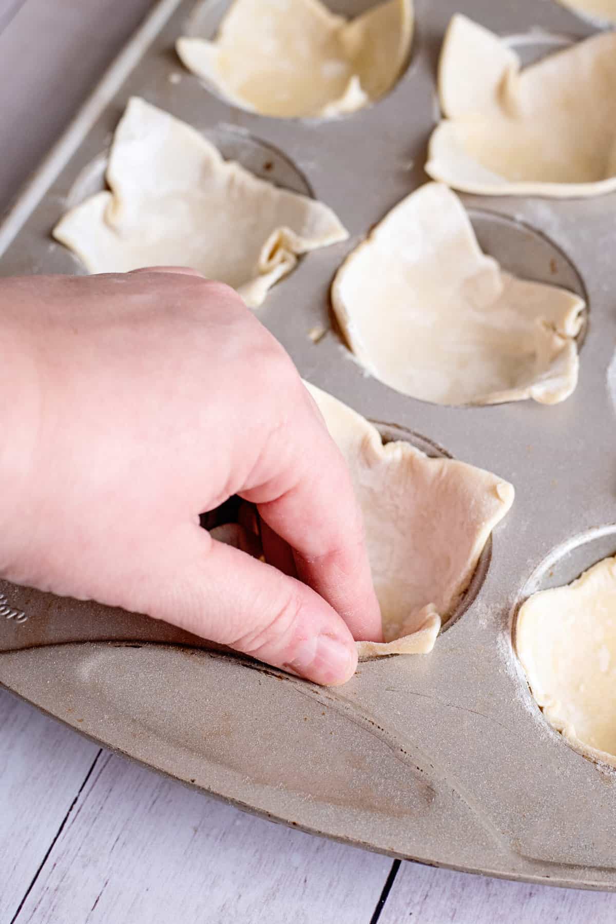 press puff pastry squares into tins