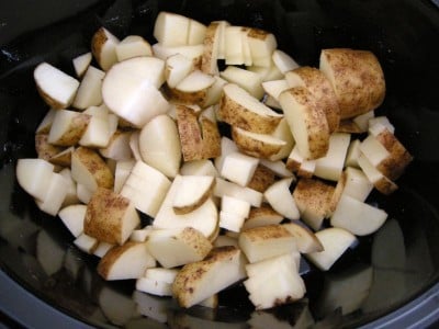 Place chopped potatoes in slow cooker.